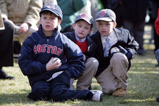 Young kids sit in awe wearing Boston Red Sox caps and holding baseballs hoping to get autographs during the Red Sox visit to the White House Wednesday, Feb. 27, 2008, on the South Lawn. White House photo by Chris Greenberg