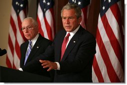 President George W. Bush stands with Attorney General Michael Mukasey as he addresses the National Association of Attorneys General at a drop-by briefing Monday, March 3, 2008, in the Eisenhower Executive Office Building. White House photo by Joyce N. Boghosian