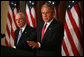 President George W. Bush stands with Attorney General Michael Mukasey as he addresses the National Association of Attorneys General at a drop-by briefing Monday, March 3, 2008, in the Eisenhower Executive Office Building. White House photo by Joyce N. Boghosian