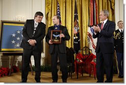 President George W. Bush applauds after presenting the Medal of Honor posthumously to family members of U.S. Army Master Sgt. Woodrow Wilson Keeble, Monday, March 3, 2008 in the East Room of the White House, in honor of Master Sgt. Keeble’s gallantry during his service in the Korean War. Kurt Bluedog, left, Keeble’s great nephew, and Russ Hawkins, a step-son, accepted the award honoring Keeble, the first full-blooded Sioux Indian to receive the Medal of Honor. White House photo by Eric Draper