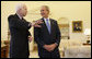 President George W. Bush smiles as he listens to Senator John McCain Wednesday, March 5, 2008, in the Oval Office as they prepared to meet the media on the South Lawn. The President offered his endorsement of the Republican presidential candidate saying, "John showed incredible courage and strength of character and perseverance in order to get to this moment. And that's exactly what we need in a President: somebody that can handle the tough decisions; somebody who won't flinch in the face of danger." White House photo by Eric Draper