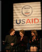 Mrs. Laura Bush applauds as she's joined on stage by Ms. Henrietta Fore, left, Administrator of the U.S. Agency for International Development and Director of the United States Foreign Assistance, and Ambassador Paula Dobriansky, Under Secretary of State for Democracy and Global Affairs, for the USAID Celebration of International Women's Day Friday, March 7, 2008, at the Ronald Reagan Building in Washington, D.C. White House photo by Joyce N. Boghosian