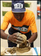 A student works on a sculpture Thursday, March 13, 2008, during Mrs. Laura Bush's visit to the IDEJEN educational program at the College de St. Martin Tours, in Port-au-Prine, Haiti. White House photo by Shealah Craighead