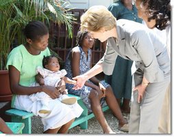 Mrs. Laura Bush is introduced to a participant and her infant daughter at the GHESKIO HIV/AIDS Center’s women’s clinic, Thursday, March 13, 2008, in Port-au-Prince, Haiti. The program was initiated to help improve the lives of HIV patients. White House photo by Shealah Craighead