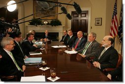 President George W. Bush is flanked by Ben Bernanke, Chairman of the Federal Reserve, and Hank Paulson, Secretary of the Treasury, during a meeting at the White House Monday, March 17, 2008, with the President's Working Group on Financial Markets. White House photo by Joyce N. Boghosian