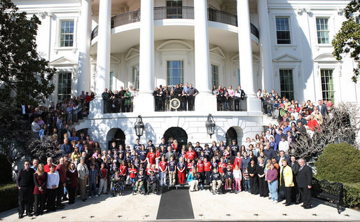 President George W. Bush joins the children and parents of the Children's Miracle Network Champion Children for a photo on the South Portico of the White House, Monday, March 17, 2008. White House photo by Shealah Craighead