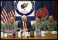 Vice President Dick Cheney shares a light moment with 19-year-old Silver Star Medal recipient U.S. Army Specialist Monica Brown, center right, during a dinner with U.S. troops Thursday, March 20, 2008 at Bagram Air Base, Afghanistan. Joining the Vice President and Spc. Brown are from left: TSgt. Vernon Jones; Army Commendation Medal for Valor recipient Spc. Charles Bell; and Spc. Brown's brother, infantryman Justin Brown. White House photo by David Bohrer