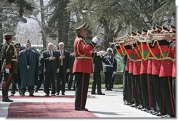 Vice President Dick Cheney is joined by President Hamid Karzai of Afghanistan for the playing of the national anthem of the United States Thursday, March 20, 2008, during an arrival ceremony at Gul Khana Palace in Kabul. While in Afghanistan the Vice President held meetings with President Karzai and visited Bagram Air Base for a classified briefing and dinner with U.S. troops. White House photo by David Bohrer