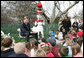 Hall of Fame football player Troy Aikman reads "One Fish, 2 Fish, Red Fish, Blue Fish" for children at the reading nook at the 2008 White House Easter Egg Roll, Monday, March 24, 2008. White House photo by Chris Greenberg