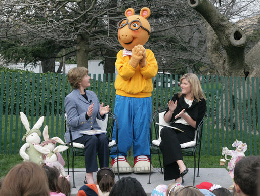 Mrs. Laura Bush, joined by her daughter, Jenna, applauds the PBS character "Arthur," following the reading of "Arthur Meets the President," Monday, March 24, 2008, during festivities at the 2008 White House Easter Egg Roll on the South Lawn of the White House. White House photo by Patrick Tierney