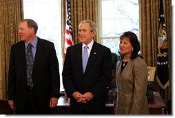 President George W. Bush speaks to reporters with Alton Jones, 2008 Bassmaster Classic Champion, and Judy Wong, 2008 Women's Bassmaster Tour Champion Tuesday, Mar. 25, 2008, in the Oval Office at the White House. White House photo by Joyce N. Boghosian