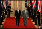 President George W. Bush and Australian Prime Minister Kevin Rudd walk together through Cross Hall to the East Room of the White House Friday, March 28, 2008, for their joint press availability. White House photo by Joyce N. Boghosian