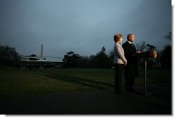 President George W. Bush, accompanied by Mrs. Laura Bush, talks to reporters before their departure to Ukraine Monday, March 31, 2008, on the South Lawn of the White House. President Bush urges Congress to pass the FISA reform bill and to act quickly to approve the Colombian Free Trade Agreement. President and Mrs. Laura Bush depart on a six-day trip to Ukraine, Romania, Croatia, and Russia. President Bush will have a scheduled meeting with Russian President Vladimir Putin. White House photo by David Bohrer