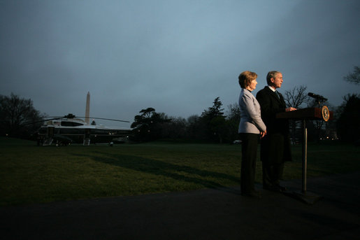 President George W. Bush, accompanied by Mrs. Laura Bush, talks to reporters before their departure to Ukraine Monday, March 31, 2008, on the South Lawn of the White House. President Bush urges Congress to pass the FISA reform bill and to act quickly to approve the Colombian Free Trade Agreement. President and Mrs. Laura Bush depart on a six-day trip to Ukraine, Romania, Croatia, and Russia. President Bush will have a scheduled meeting with Russian President Vladimir Putin. White House photo by David Bohrer