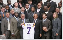 President George W. Bush holds up an LSU Tigers' jersey presented to him Monday, April 7, 2008 by the 2007 NCAA Football Champions during their visit to the White House. White House photo by Chris Greenberg