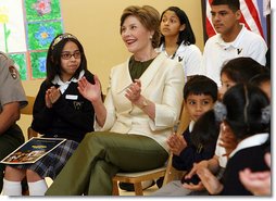 Mrs. Laura Bush applauds program speakers as she joins students from the Williams Preparatory School in Dallas, Thursday, April 10, 2008, during events at the First Bloom program to help encourage youth to get involved with conserving America's National Parks. Through the First Bloom program, the National Park Foundation and the National Park Services are joining with the Lady Bird Johnson Wildflower Center and community groups to connect young people to our national parks. White House photo by Shealah Craighead