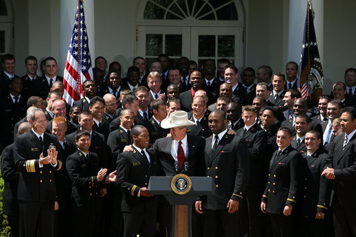 President George W. Bush joins the United States Naval Academy Football Team Monday, April 14, 2008, following the presentation of the Commander-in-Chief's Trophy to the The Naval Academy Midshipmen in the Rose Garden of the White House. White House photo by Joyce N. Boghosian