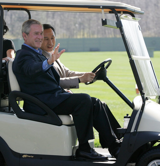 President George W. Bush waves as South Korean President Lee Myung-bak drives their golf cart Friday, April 18, 2008, at the Presidential retreat at Camp David, Md. White House photo by Joyce N. Boghosian