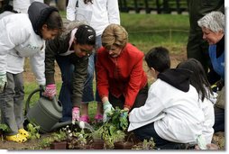 Mrs. Laura Bush helps children plant flowers at the First Bloom Event, Monday, April 21, 2008, during her visit to celebrate National Park week at the Castle Clinton National Monument in New York City. White House photo by Shealah Craighead