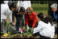 Mrs. Laura Bush helps children plant flowers at the First Bloom Event, Monday, April 21, 2008, during her visit to celebrate National Park week at the Castle Clinton National Monument in New York City. White House photo by Shealah Craighead