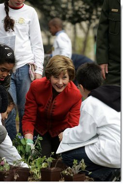 Mrs. Laura Bush helps children plant flowers at the First Bloom Event, Monday, April 21, 2008, during her visit to celebrate National Park week at the Castle Clinton National Monument in New York City. White House photo by Shealah Craighead