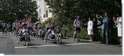 President George W. Bush sounds the horn to kick off the Wounded Warriors Soldier Ride Thursday, April 24, 2008, on the South Lawn drive at the White House. With him is Secretary of State Condoleezza Rice. White House photo by Chris Greenberg