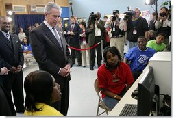 President George W. Bush looks over the shoulders of middle school students as they work on projects for Malaria Awareness Day Friday, April 25, 2008, during his visit to the Northwest Boys & Girls Club in Hartford, Conn. White House photo by Chris Greenberg