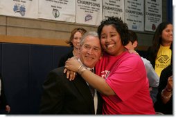 President George W. Bush is embraced by Boys and Girls Club member Melodie Williams as they pose for a photo Friday, April 25, 2008, during the President's visit to the Northwest Boys & Girls Club in Hartford, Conn., where the Boys & Girls members were learning about the cause and prevention of malaria. White House photo by Chris Greenberg