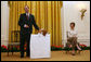 Mrs. Laura Bush looks on as the Westminster Kennel Club's 2008 Best in Show Winner, Uno, and his co-owner Eddie Dziuk address guests during their visit to the White House Monday, May 5, 2008, in the East Room of the White House. White House photo by Joyce N. Boghosian