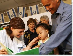 Mrs. Laura Bush looks on during an examination of 1-year-old Orie Holkan during a visit Wednesday, May 14, 2008, to the Tipat Chalav-Gonenim Neighborhood Mother and Child Care Center in Jerusalem. With them are Ms. Sarit Fuast, the nurse, and Talala Holkan, the young child’s father. White House photo by Shealah Craighead