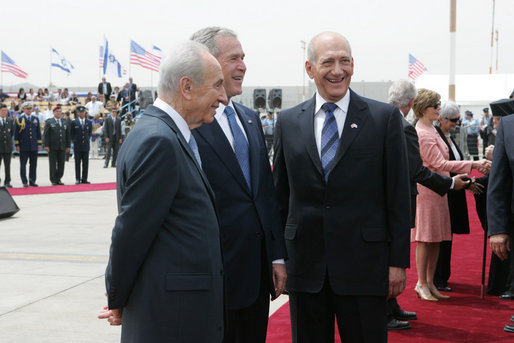 President George W. Bush shares a smile with Israel’s President Shimon Peres, left, and Prime Minister Ehud Olmert, as arrival ceremonies wind down Wednesday, May 14, 2008, at Ben Gurion International Airport for the U.S. leader and Mrs. Laura Bush. White House photo by Joyce N. Boghosian