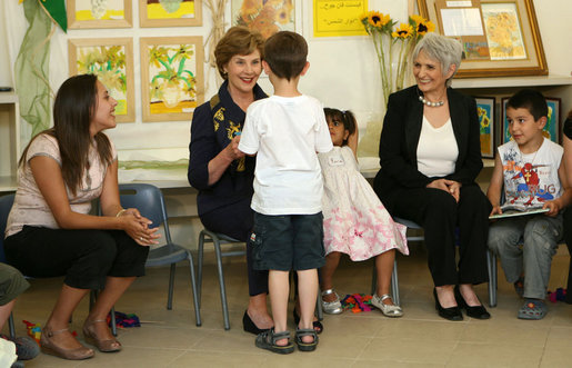 Mrs. Laura Bush shares a moment with a kindergarten student Wednesday, May 14, 2008, at the Hand in Hand School for Jewish-Arab Education in Jerusalem. Mrs. Bush took the opportunity to visit the school with Mrs. Aliza Olmert, right, spouse of Israeli Prime Minister Ehud Olmert. White House photo by Shealah Craighead