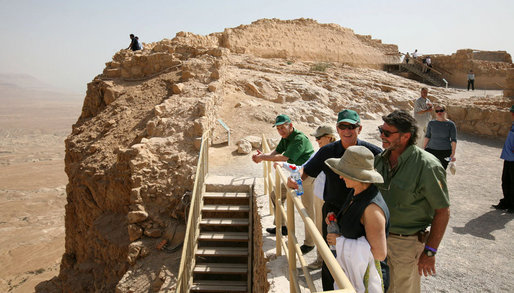 President George W. Bush and Mrs. Laura Bush stand with Mrs. Aliza Olmert, spouse of Israeli Prime Minister Ehud Olmert, as they listen to Eitan Campbell, Director of the Masada National Park, during a visit to the historic site Thursday, May 15, 2008, in Masada, Israel. White House photo by Joyce N. Boghosian