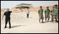 President George W. Bush waves goodbye to a group of young American men who are volunteering their time at Masada National Park in Masada, Israel. White House photo by Joyce N. Boghosian