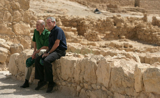 President George W. Bush and Prime Minister Ehud Olmert sit on a wall as they take a break from their tour of Masada Thursday, May 15, 2008. The President and Mrs. Laura Bush took the opportunity to visit the historic site during their two-day visit to Israel to help celebrate the 60 anniversary of the country’s independence. White House photo by Shealah Craighead