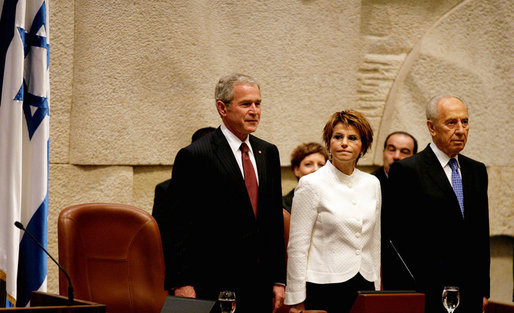 President George W. Bush stands with Dalia Itzik, Speaker of the Knesset, and Israel’s President Shimon Peres on the floor of the Knesset Thursday, May 15, 2008, in Jerusalem. During his remarks to the members of the Israel parliament, President Bush said, “We gather to mark a momentous occasion. Sixty years ago in Tel Aviv, David Ben-Gurion proclaimed Israel's independence, founded on the "natural right of the Jewish people to be masters of their own fate." What followed was more than the establishment of a new country. It was the redemption of an ancient promise given to Abraham and Moses and David -- a homeland for the chosen people Eretz Yisrael.” White House photo by Shealah Craighead