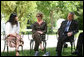 Mrs. Laura Bush and President George W. Bush listen to a young participant during a roundtable discussion Friday, May 16, 2008, in the garden of the Bible Lands Museum Jerusalem. White House photo by Joyce N. Boghosian