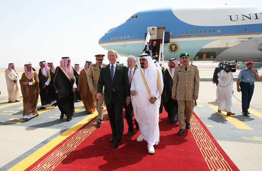 President George W. Bush and King Abdullah bin Abdulaziz walk with an entourage of greeters Friday, May 16, 2008, after the President’s arrival at Riyadh-King Khaled International Airport in Riyadh. White House photo by Joyce N. Boghosian