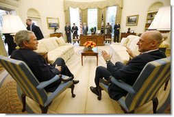 President George W. Bush and U.S. Treasury Secretary Henry Paulson talk together during their meeting on economic issues Monday morning, May 19, 2008, in the Oval Office. White House photo by Eric Draper