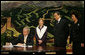 President George W. Bush signs his condolences for the victims of China's May 12 earthquake as he and Mrs. Laura Bush visit the Embassy of the People's Republic of China Tuesday, May 20, 2008, in Washington, D.C. With them are China's Ambassador to the United States Wenzhong Zhou and his spouse, Shumin Xie. White House photo by Joyce N. Boghosian