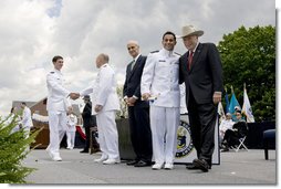 Vice President Dick Cheney poses for a photograph with a U.S. Coast Guard Academy graduate, Wednesday, May 21, 2008, during commencement exercises in New London, Conn. White House photo by David Bohrer