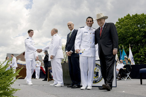 Vice President Dick Cheney poses for a photograph with a U.S. Coast Guard Academy graduate, Wednesday, May 21, 2008, during commencement exercises in New London, Conn. White House photo by David Bohrer