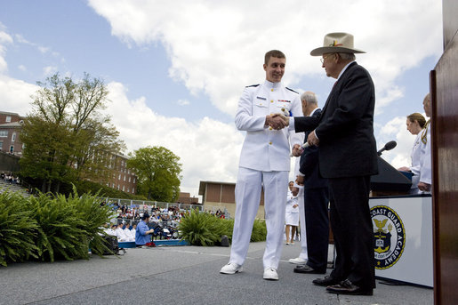 Vice President Dick Cheney presents commission papers to a U.S. Coast Guard Academy graduate, Wednesday, May 21, 2008, during commencement exercises in New London, Conn. During his address to the graduates the Vice President said, "This branch of the armed forces has given steady service to the United States of America since the year 1790 -- and in that time the Coast Guard has saved more than a million lives." He added, "As you step forward to accept new duties, your fellow citizens look up to you for the oath you take, the traditions you uphold, and the standards you live by." White House photo by David Bohrer