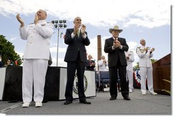 Vice President Dick Cheney is joined by Admiral Thad Allen, Commandant of the U.S. Coast Guard, left, and Secretary Michael Chertoff of Homeland Security, center, in applauding the graduates of the U.S. Coast Guard Academy, Wednesday, May 21, 2008, during commencement exercises in New London, Conn. White House photo by David Bohrer