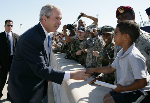 President George W. Bush greets a young boy on his arrival to Pope Air Force Base in Fort Bragg, N.C., Thursday, May 22, 2008. White House photo by Chris Greenberg