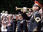 President George W. Bush is accompanied by Major General Richard J. Rowe Jr., commander of the Military District of Washington, right, as he holds his hand over his heart during the playing of taps at the Tomb of the Unknowns during a Memorial Day ceremony Monday, May 26, 2008 at Arlington National Cemetery in Arlington, VA. White House photo by Chris Greenberg