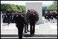 President George W. Bush, accompanied by Major General Richard J. Rowe Jr., commander of the Military District of Washington, foreground left, lays a wreath at the Tomb of the Unknowns Monday, May 26, 2008, during a Memorial Day ceremony at Arlington National Cemetery in Arlington, VA. White House photo by Shealah Craighead