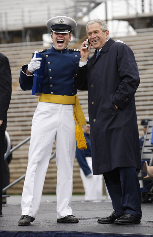 President George W. Bush shares a phone conversation with a graduate of the United States Air Force Academy Wednesday, May 28, 2008, after commencement ceremonies in Colorado Springs. The President told the class of 2008, "You're the 50th graduating class in the history of the Air Force Academy. Each of you has worked hard to reach this moment. I'll leave this campus today filled with the confidence in the course of our struggle and the fate of our country, because I've got confidence in each of you." White House photo by Eric Draper