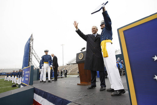 President George W. Bush and a graduate of the United States Air Force Academy wave to family and friends in the audience Wednesday, May 28, 2008, during graduation ceremonies for the Class of 2008 in Colorado Springs. The class of 1,012 cadets is the 50th to graduate from the Academy. White House photo by Eric Draper