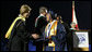 Mrs. Laura Bush congratulates a graduate during commencement exercises Thursday, May 29, 2008, at Enterprise High School in Enterprise, Alabama. Mrs. Bush was on hand to deliver the commencement address, and she told the class -- that lost four of its members in deadly tornadoes last year -- and told the Class of 2008, "As you graduate tonight, take with you memories of your teachers' and classmates' support after the storm, the blue and white worn by students at rival schools, and the donations that came pouring in from around the country." White House photo by Shealah Craighead